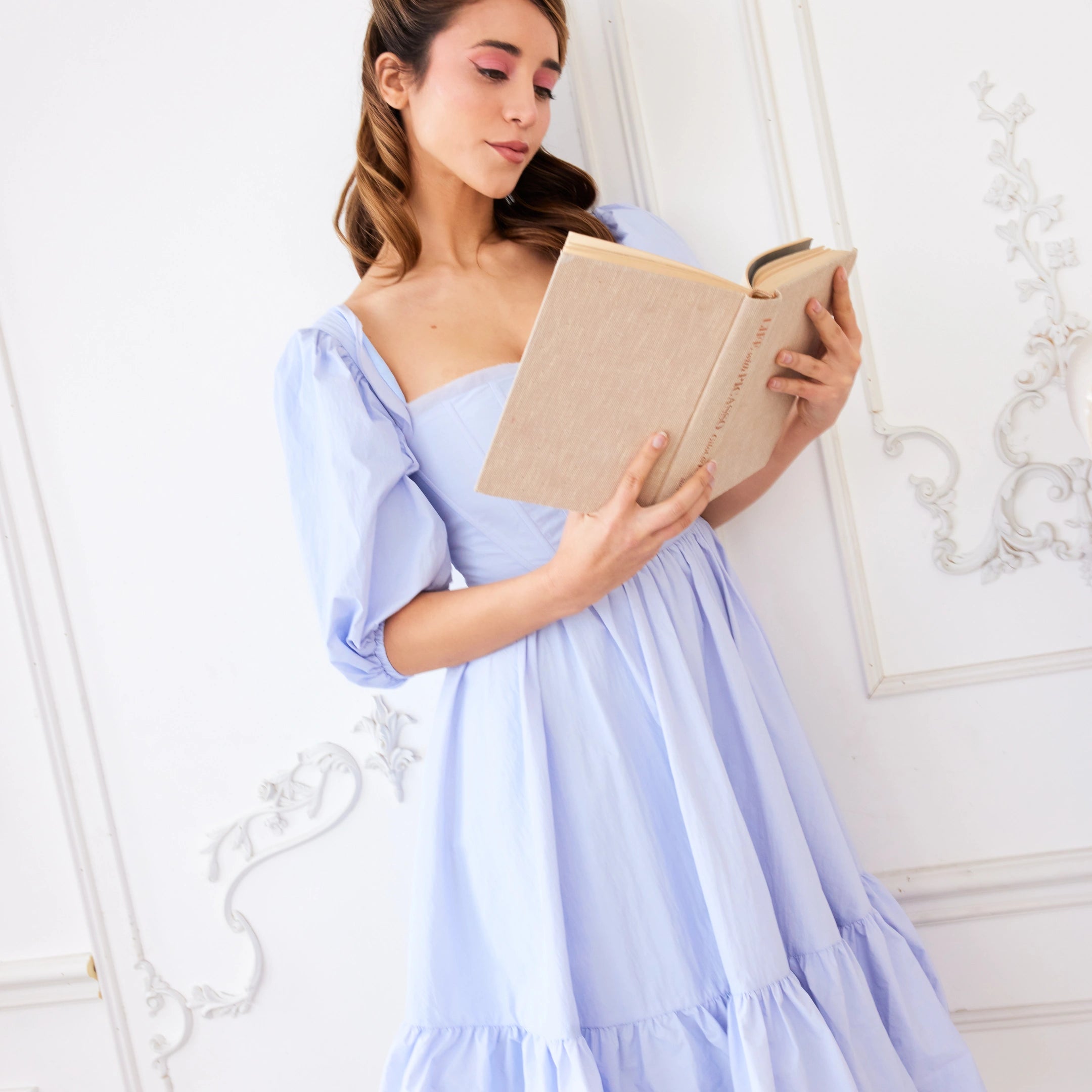 Woman in the alice blue josephine midi dress reading a diary - our sheepish stories 