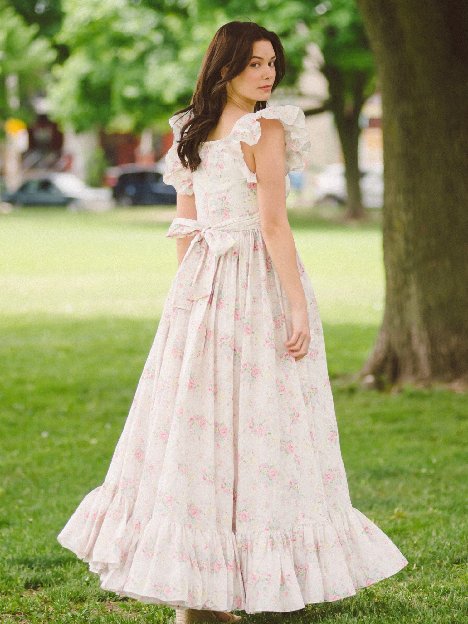 Pale pink floral apron maxi dress with ruffled cap sleeves and tiered skirt