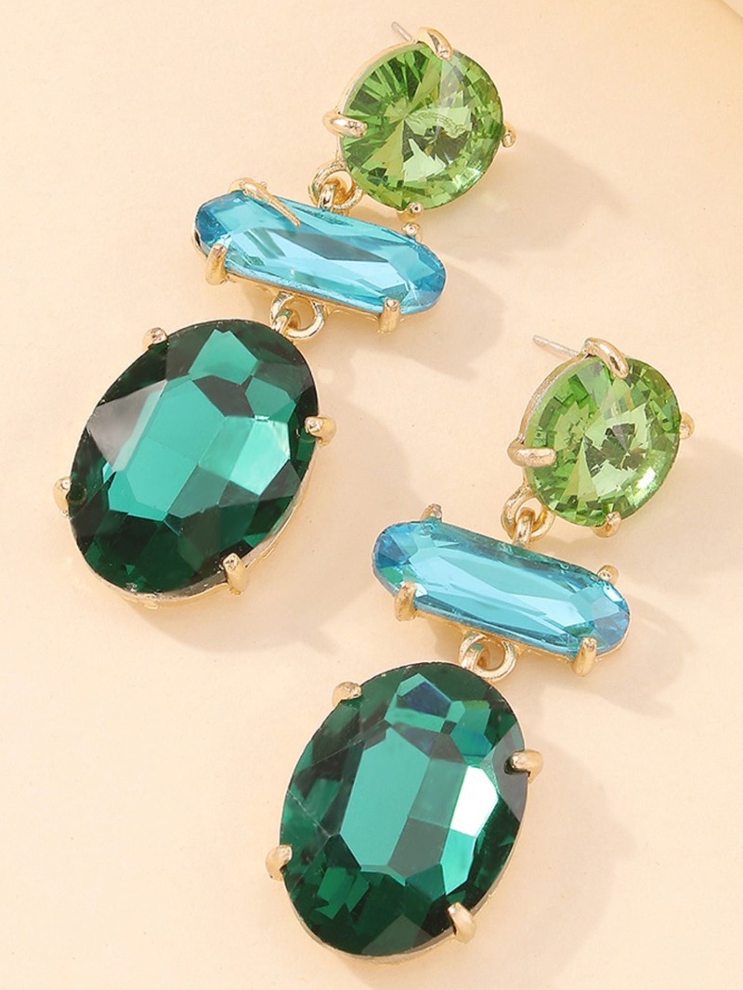 Collection of faceted gemstones in green and blue hues for Emerald Earrings statement piece