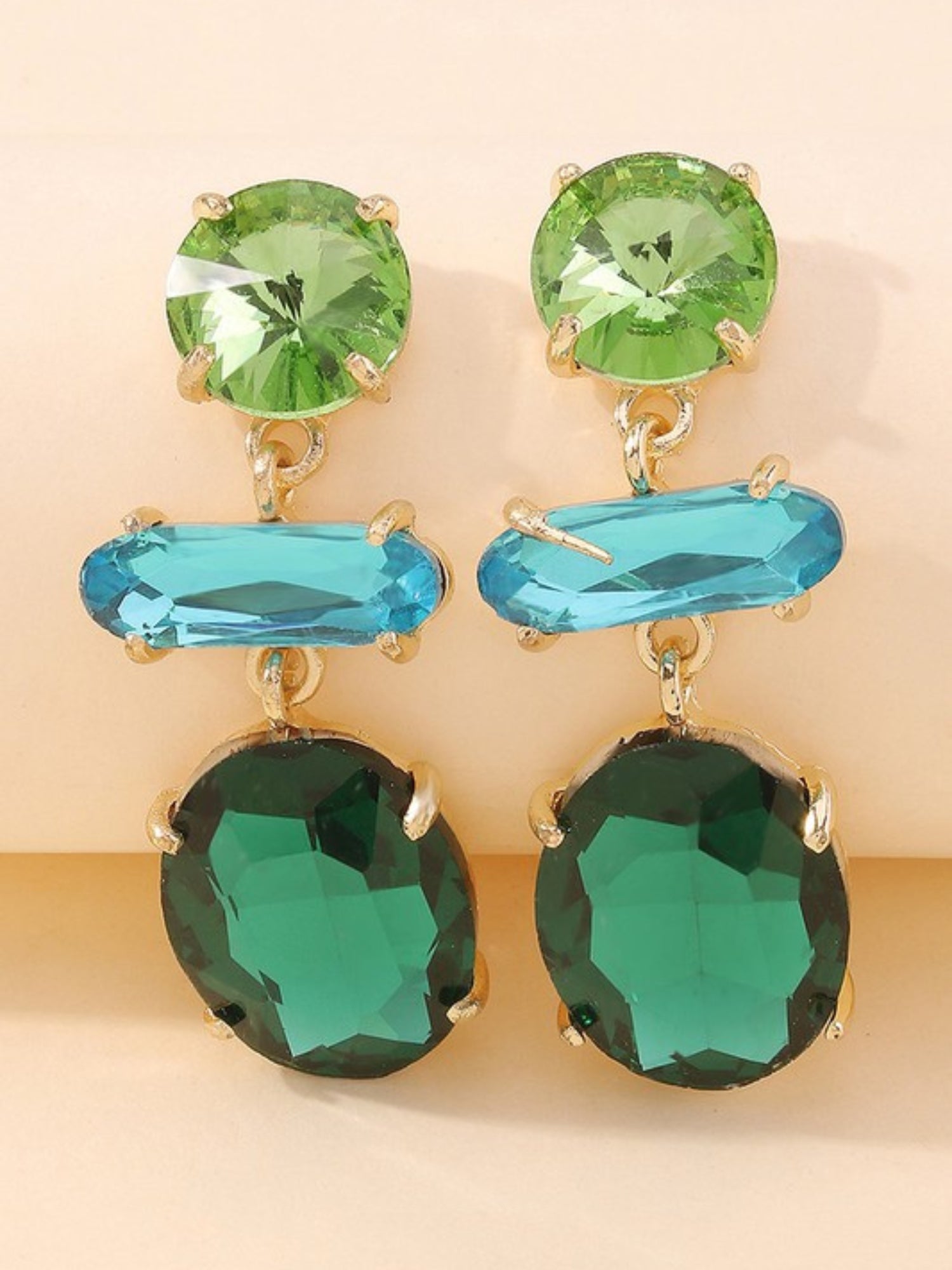 Emerald Earrings featuring a pair of dangling gemstones in green and blue hues