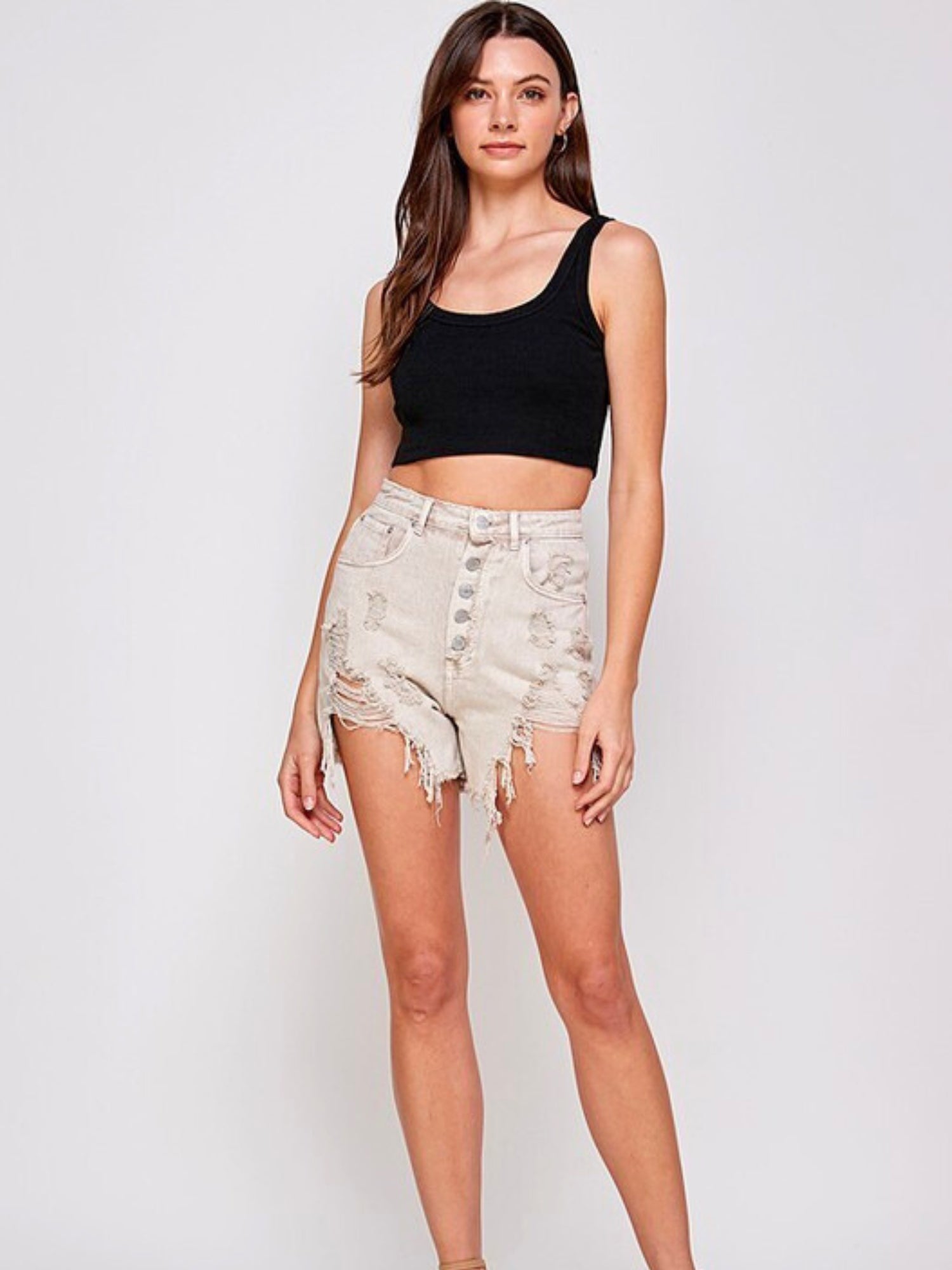 Woman in black crop top and distressed Facing Trouble Denim Shorts with high waist button