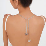 Delicate butterfly pendants on a bare back showcasing the Fairy Flutter Necklace