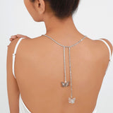 Delicate butterfly pendants on a bare back showcasing the Fairy Flutter Necklace