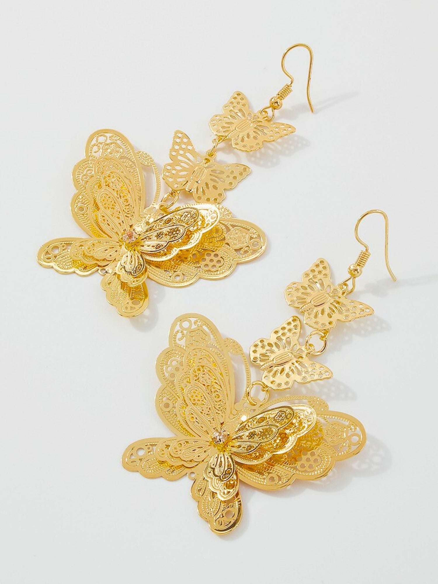 Ornate gold butterfly dangle earrings, a gilded masterpiece tailored for fairytale lovers