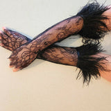 Elegant black lace gloves with feathered cuffs, perfect for pairing with a gown or puff dress