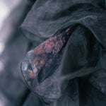Close-up detail of the puff dresses' ghostly floral print on its poly organza fabric.