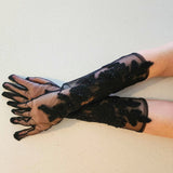 Pair of long black lace Fleur Embroidered Gloves elegantly extending up the arms