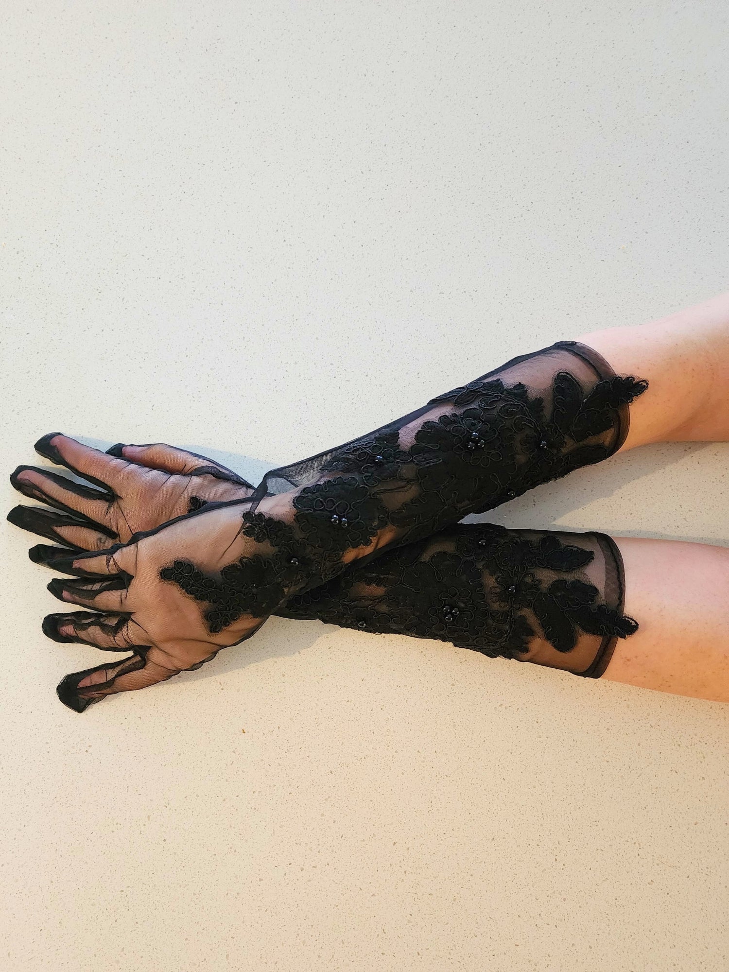 Pair of long black lace Fleur Embroidered Gloves elegantly extending up the arms