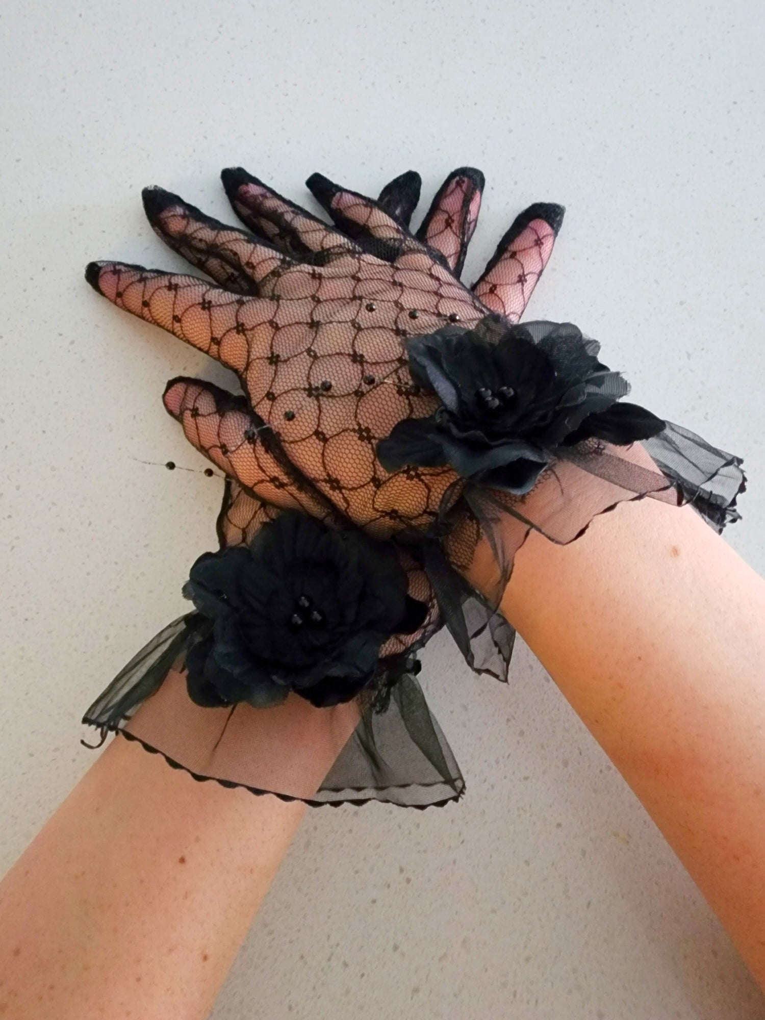 Delicate Fleur Evening Gloves with black floral accents, perfect for a gown or grand bow sash