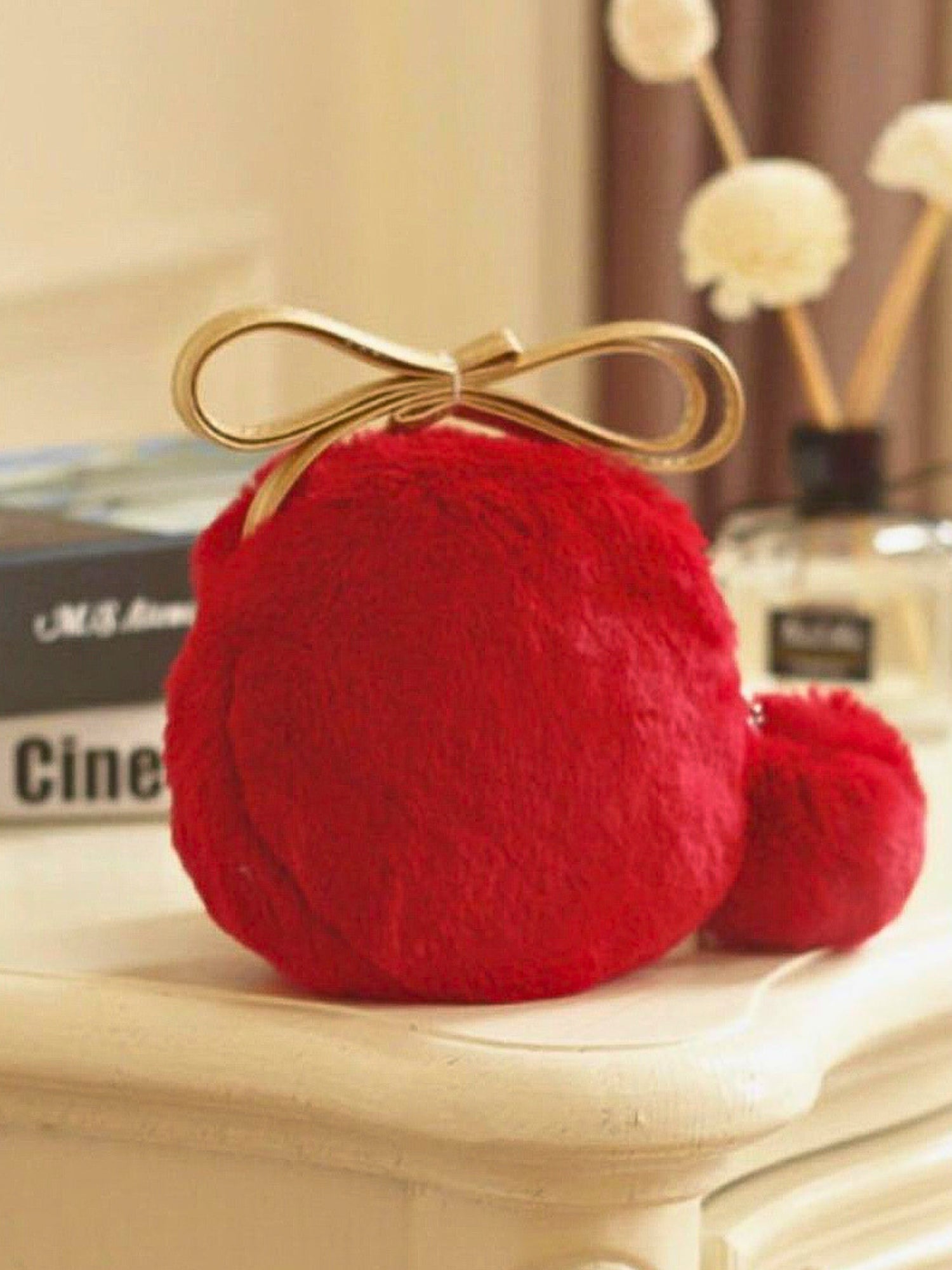 Red furry pom pom with gold bow on The Furry Pom Pom Micro Purse