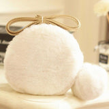 Fluffy white pom pom micro purse with a beige bow on top for stylish flair