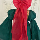 Festive dress featuring a green bodice and large red bow from The Giant Flutter Bow