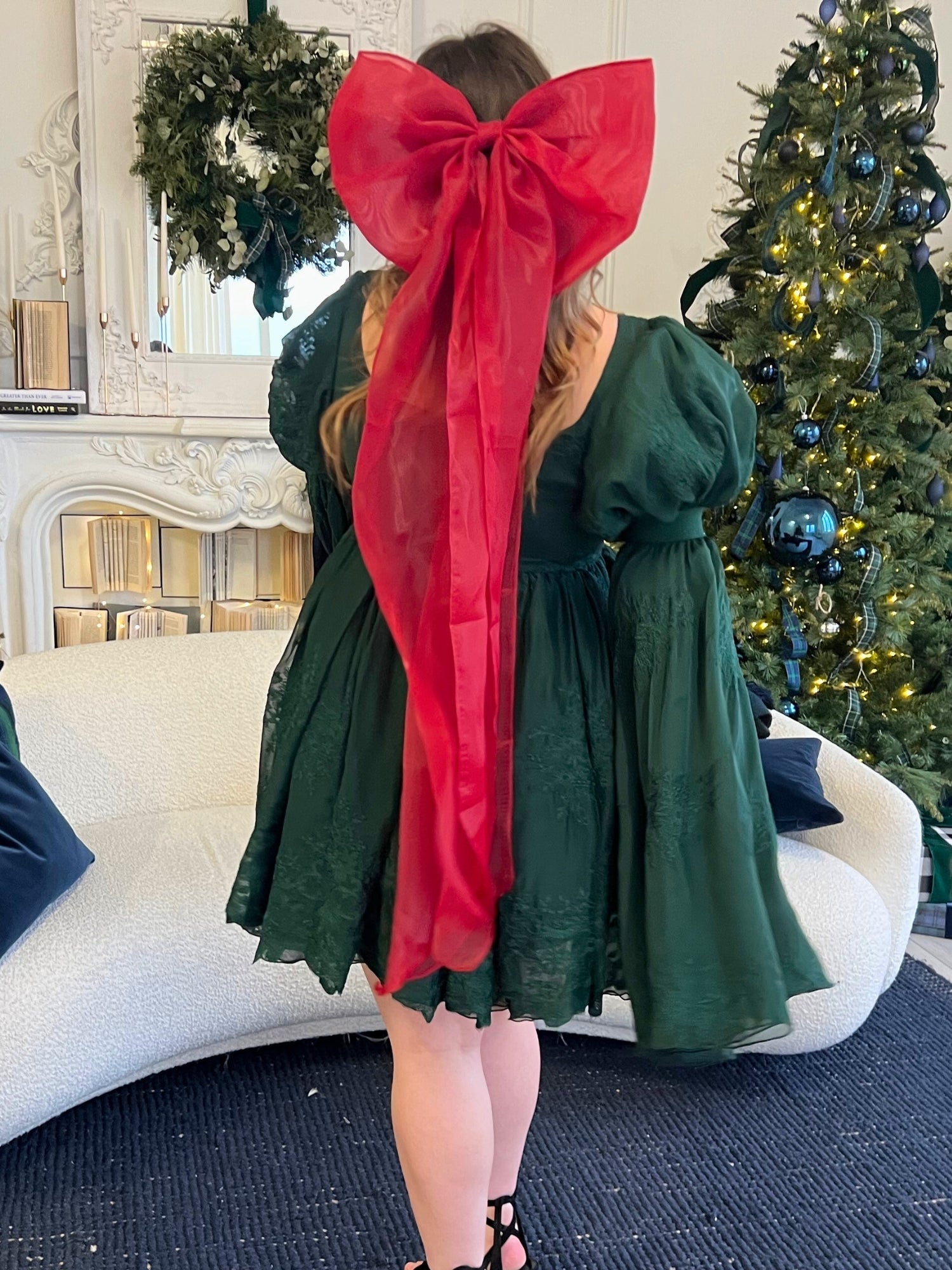 Green dress featuring a large red bow, perfect for showcasing The Giant Flutter Bow