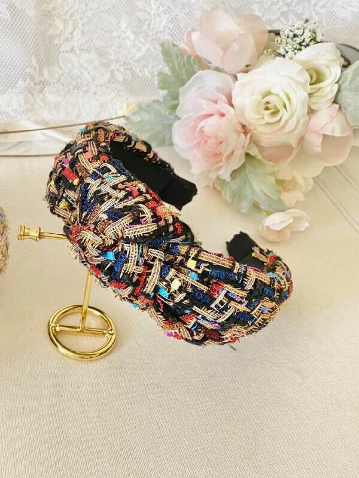 Colorful tweed headband with intricate patterns and knotted design, perfect for gowns