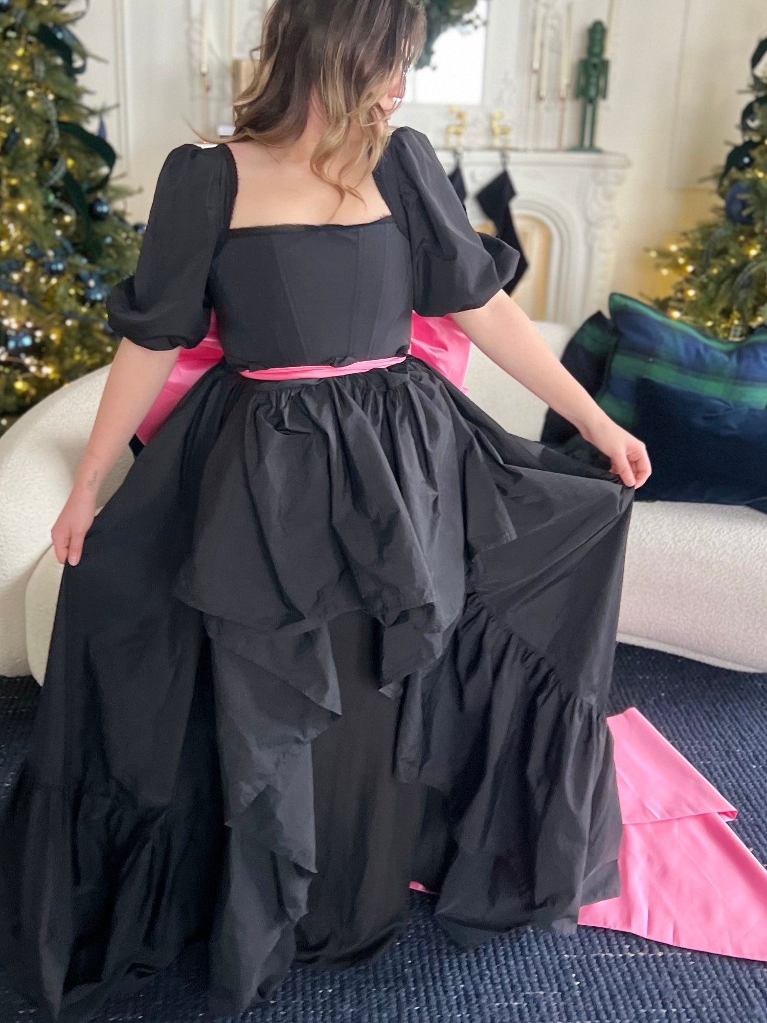 Black floor-length dress with puff sleeves featuring a Grand Bow Sash for bow lovers