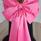 Bright pink oversized bow with trailing ribbons from The Grand Bow Sash for bow lovers