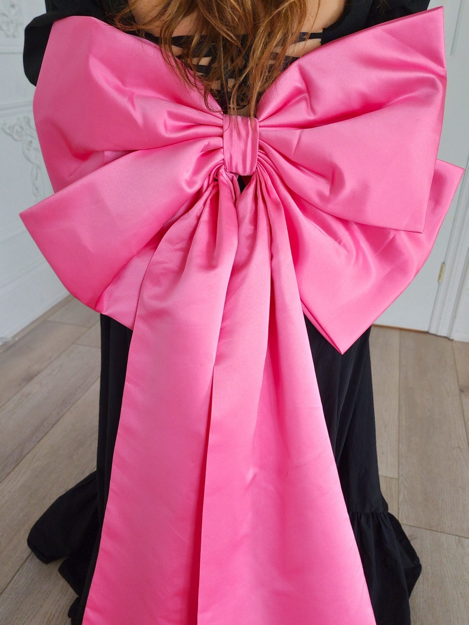 Bright pink oversized bow with trailing ribbons from The Grand Bow Sash for bow lovers