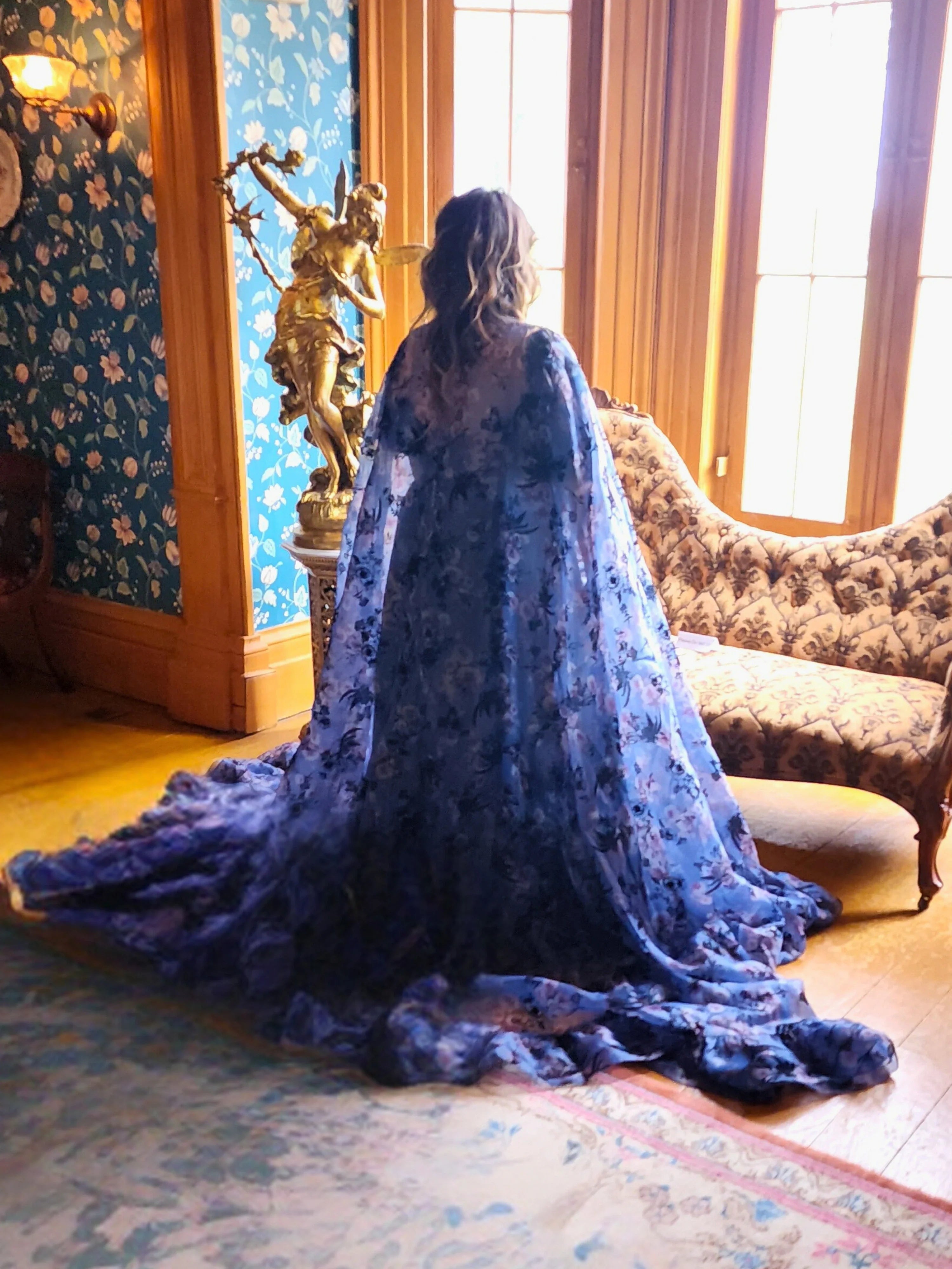 Flowing High Priestess Cape with intricate lace patterns worn by a person facing away