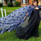 Flowing blue floral High Priestess Cape worn elegantly over a black dress