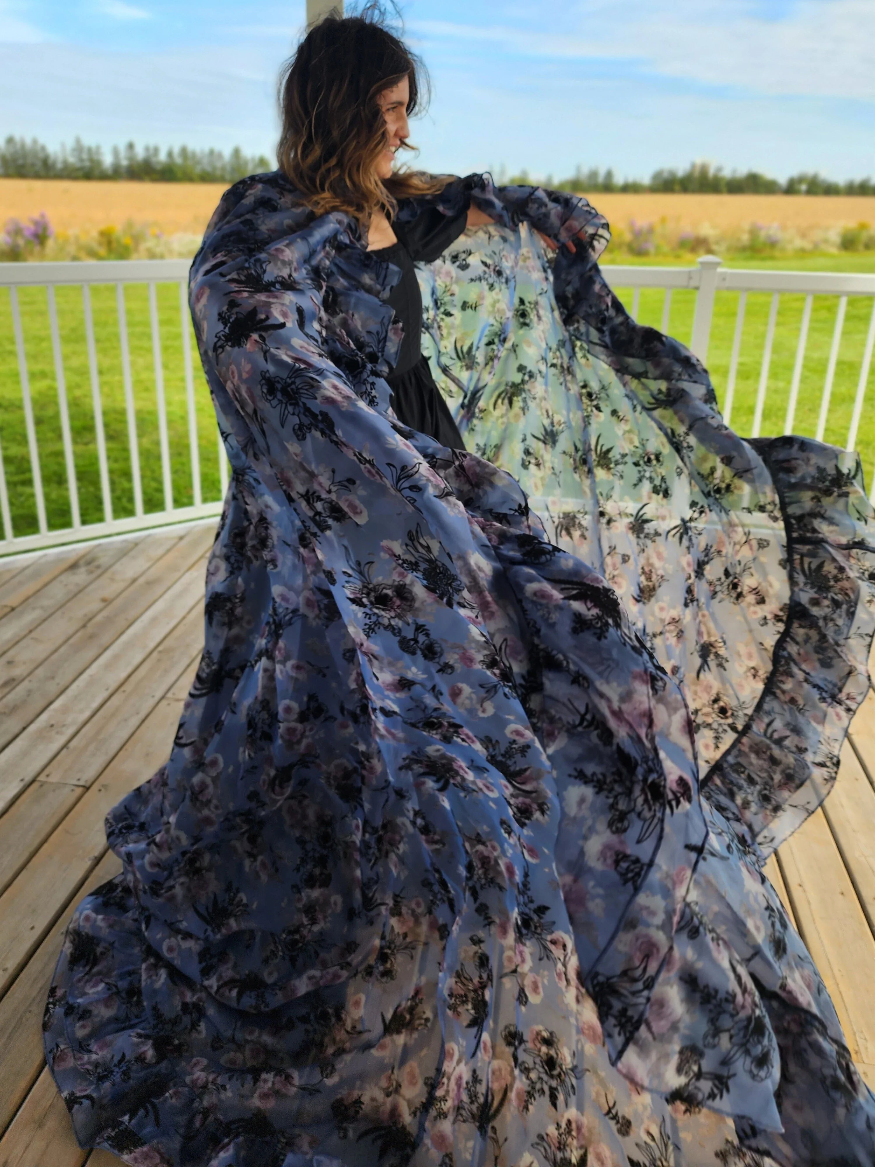 Flowing floral dress in dark blue with lighter patterns, featuring the High Priestess Cape