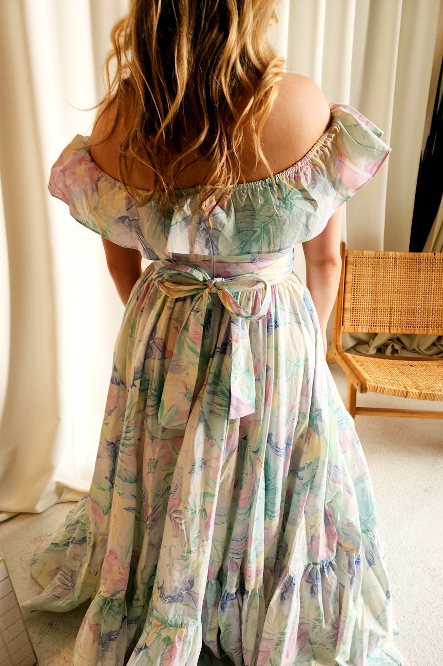 Floral off-shoulder maxi gown with ruffled neckline, perfect for a honeymoon romance