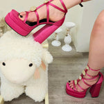 Hot Pink Platform heels showcased on top of a cute plush ivory sheep rocking chair.