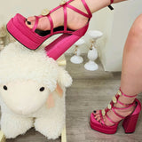 Hot Pink Platform heels showcased on top of a cute plush ivory sheep rocking chair.