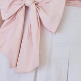 Pale pink fabric bow tied in a decorative knot on the Ivory Cloud Midi Dress