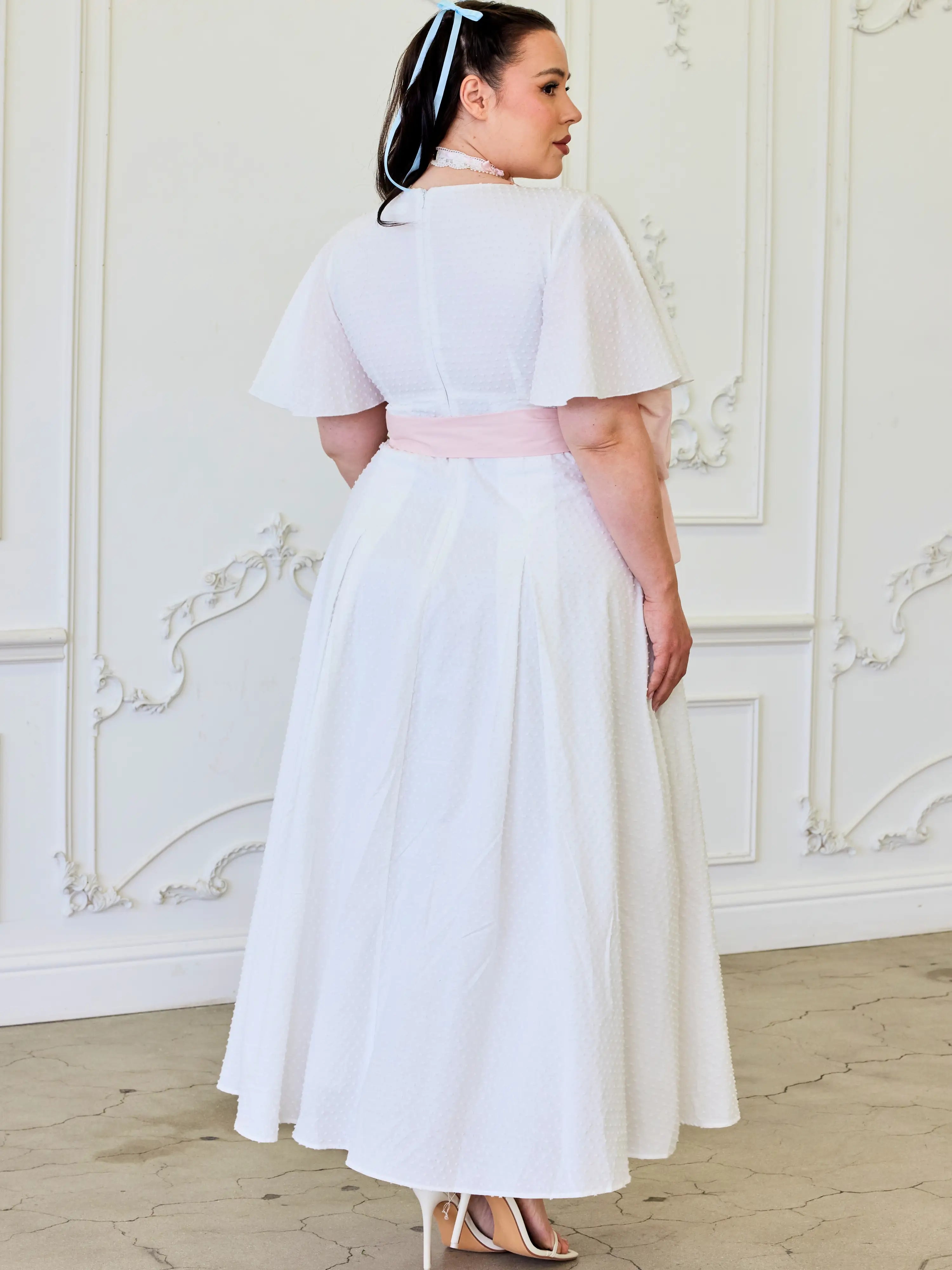 White Ivory Cloud Midi Dress with flutter sleeves and pink sash at the waist