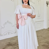 White Ivory Cloud Midi Dress featuring a pink bow sash and off-shoulder sleeves