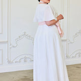 Woman in a long white dress and headpiece featuring the Ivory Cloud Midi Dress design