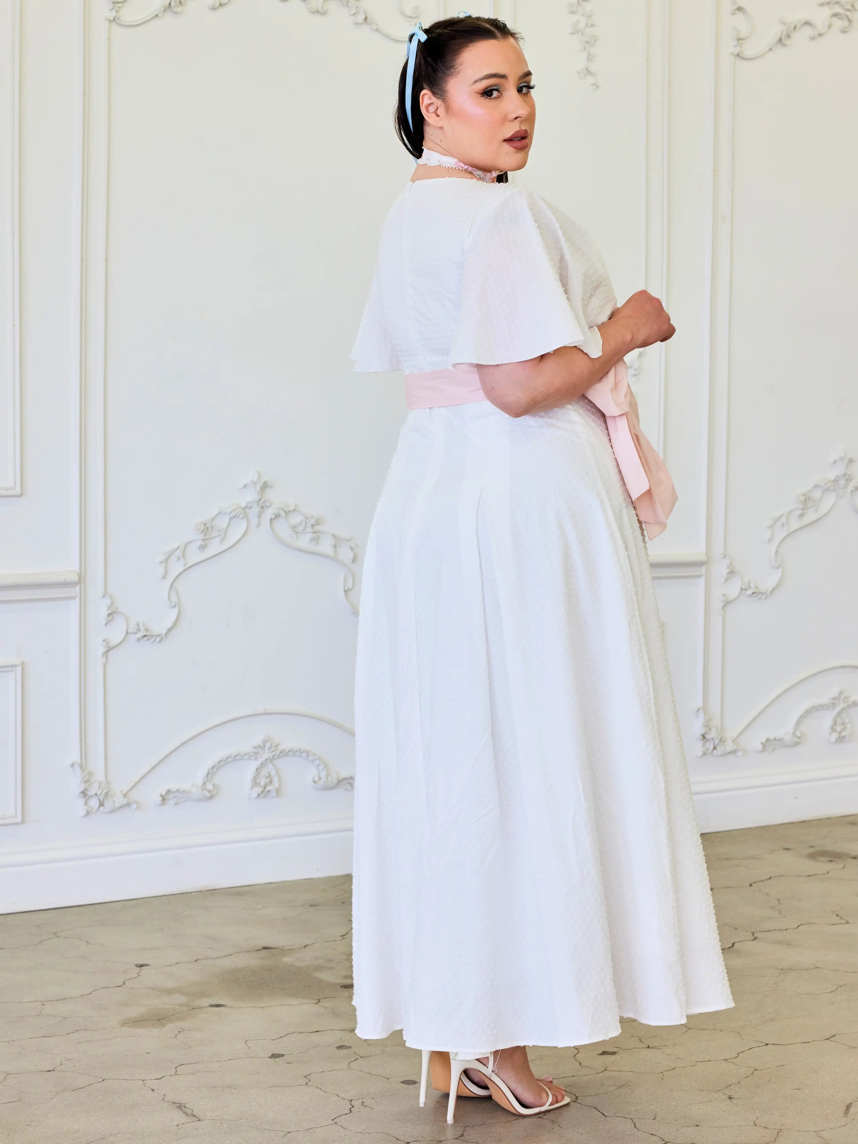 Woman in a long white dress and headpiece featuring the Ivory Cloud Midi Dress design