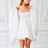 White flowy mini dress with bell sleeves and square neckline, ideal Fairy Puff Dress