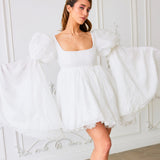 White mini dress with puff sleeves and square neckline, perfect for the Ivory Fairy Puff Dress