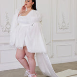 Woman in The Ivory Fairy Puff Dress with long sleeves and pink high heels