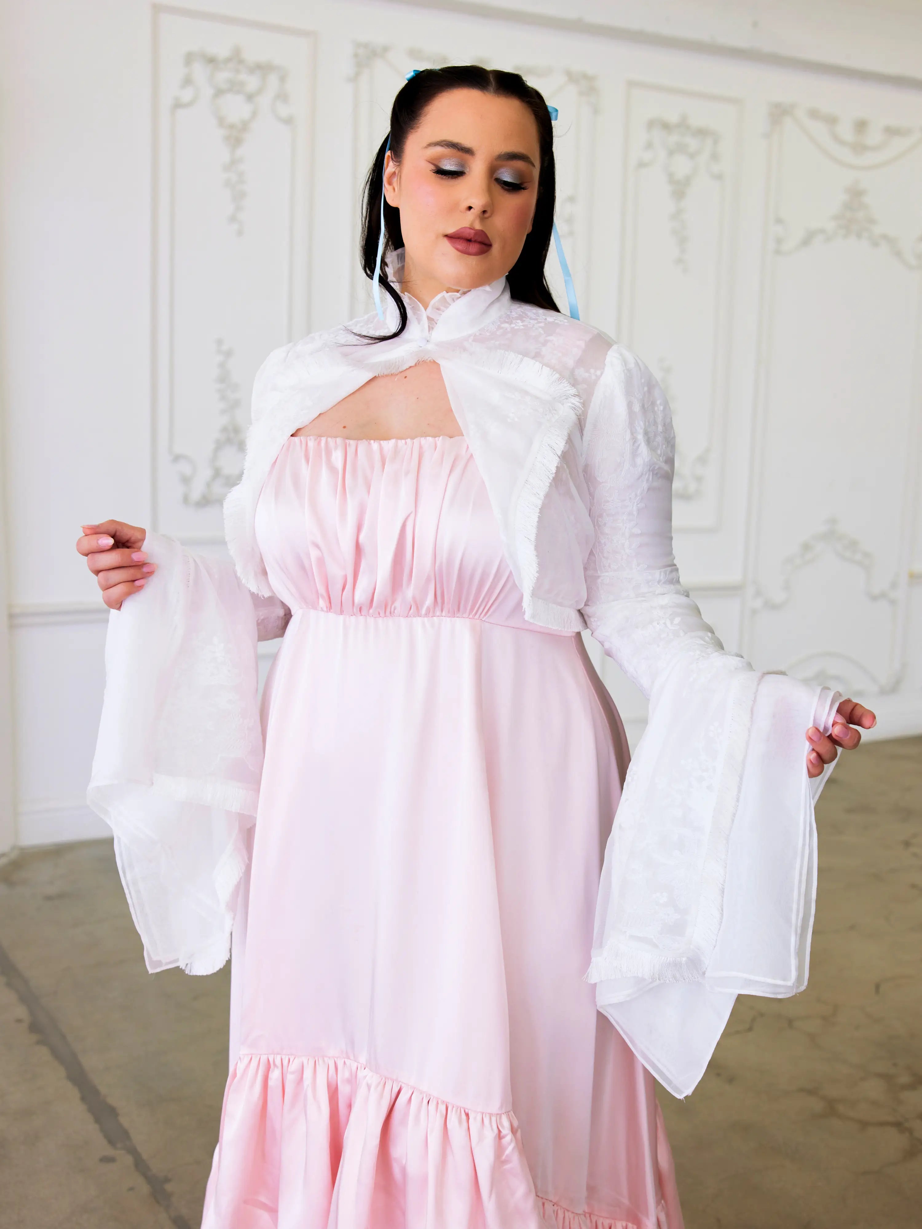 Pink and white dress with bell sleeves paired with the Ivory Lady Elizabeth Bolero