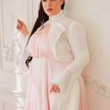 Woman in a white coat over a pink dress showcasing the Lady Elizabeth Bolero