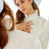 Young woman in a white top showcasing the Lady Elizabeth Bolero jacket