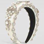 Ornate ivory pearl headband with crystals and an elegant ivory-colored base