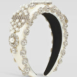 Ornate ivory pearl headband with crystals and an elegant ivory-colored base