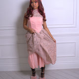 A woman wearing Ivory Sheep's Garden Party Lace Midi Dress against a white wall.