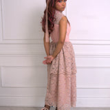 A woman wearing Ivory Sheep's Garden Party Lace Midi Dress against a white paneled wall.
