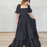 Long black Josephine Gown featuring classic puff sleeves and a tiered, ruffled skirt