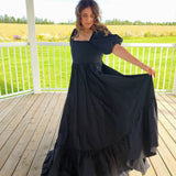 Woman in The Josephine Gown with classic puff sleeves on a wooden porch