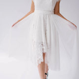 Front detail of the Belladonna Lace Dress with sheer tulle overlay and scalloped lace hem, styled for modern bridal wear.