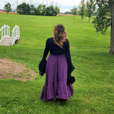 Woman in a long purple skirt and black top showcasing the Lady Elizabeth style