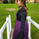 Woman in purple dress and black top showcasing the Lady Elizabeth jacket on a walkway