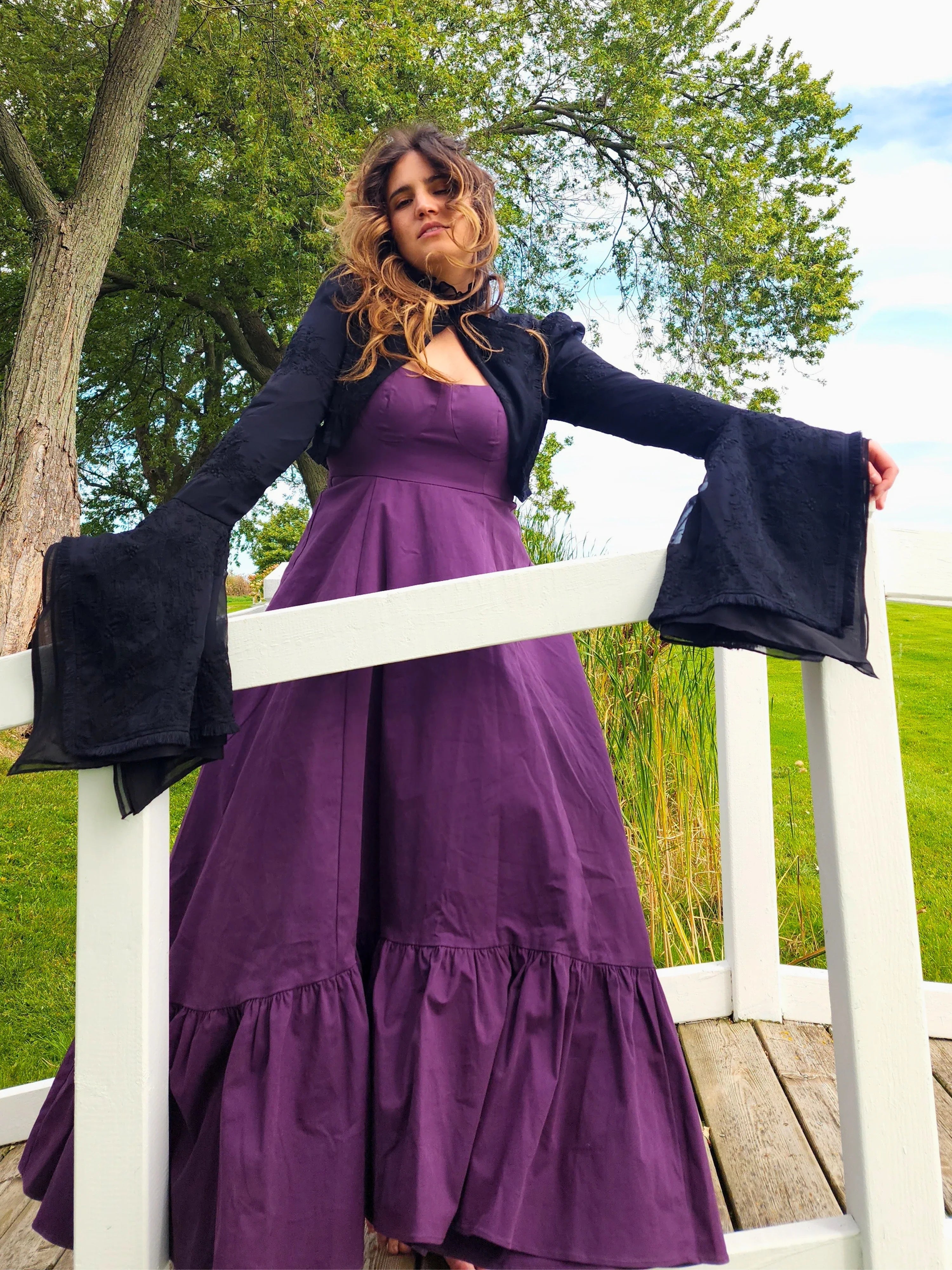 Woman in a purple maxi dress and Lady Elizabeth jacket with flared sleeves