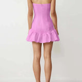 Strapless pink Lia Mini Dress featuring a stylish ruffled hem for a trendy look