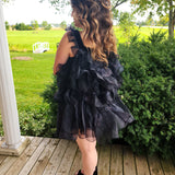 Frilly black feather mini dress with ruffled layers and off-shoulder design